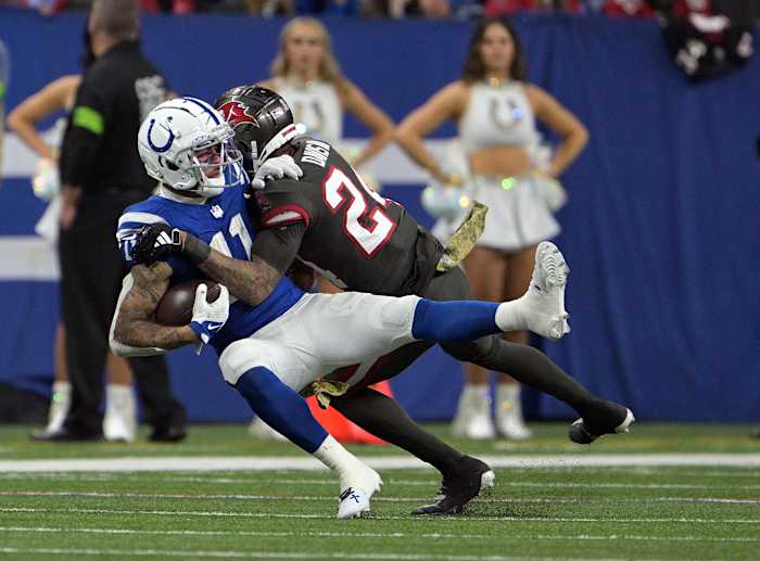 Nov 26, 2023; Indianapolis, Indiana, USA; Indianapolis Colts wide receiver Michael Pittman Jr. (11) is tackled by Tampa Bay Buccaneers cornerback Carlton Davis III (24) during the second half at Lucas Oil Stadium.